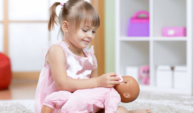 girl-playing-with-baby-doll