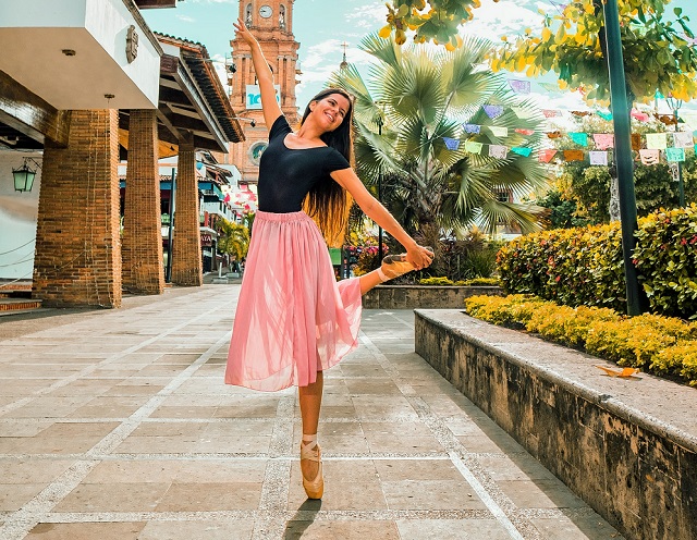 picture of a woman outside a building in a garden dancing ballet with full-sole kind of shoes ballet essentials