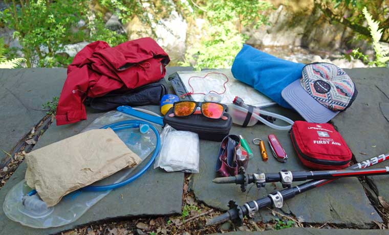 Hiking Essentials Checklist - sunglasses, suncream, hat, hydration pack