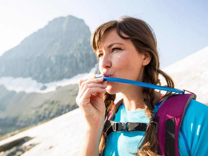 Woman Drinking Water from Hydratation Pack