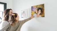 mom showing her daughter acrylic wall prints of their photos