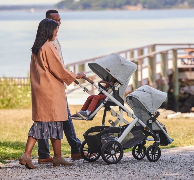 parents walking with their children in double stroller