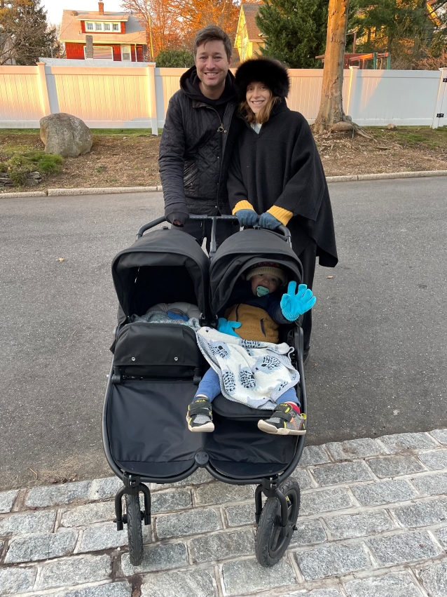 parents with their children in double stroller