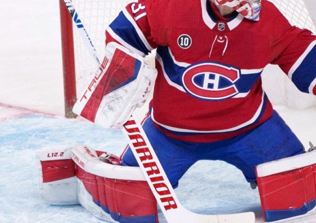 The goalie is keeping the goal with a Warrior stick
