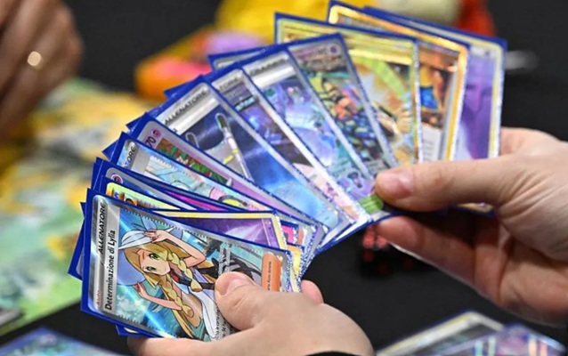person playing with pokemon tcg
